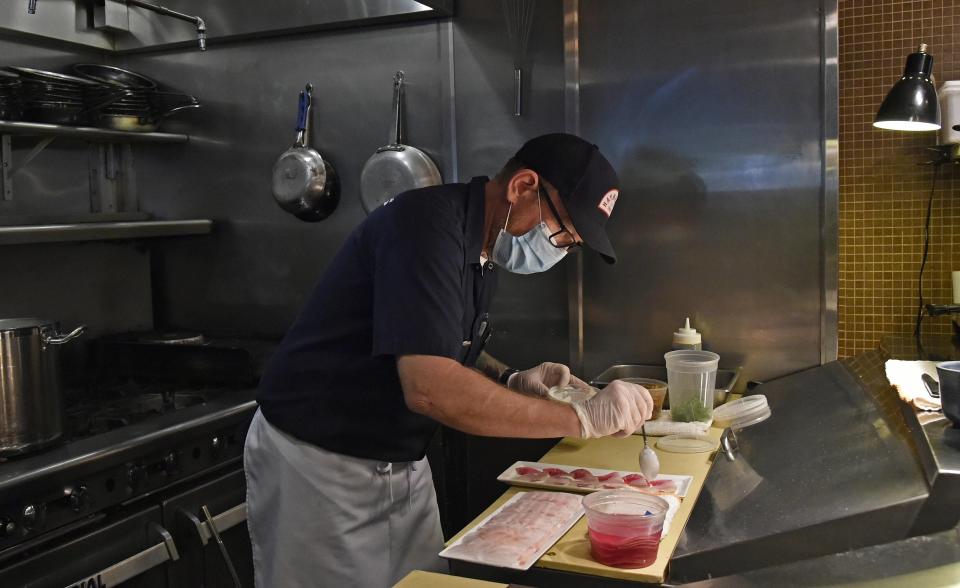 Owner/chef Steve Phelps prepares a dish inside his Sarasota restaurant Indigenous.