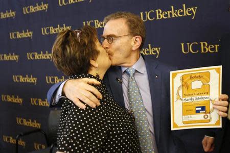 Randy Schekman (R), professor of molecular and cell biology at the University of California at Berkeley, kisses his wife Nancy Walls after a press conference in Berkeley, California October 7, 2013. REUTERS/Stephen Lam