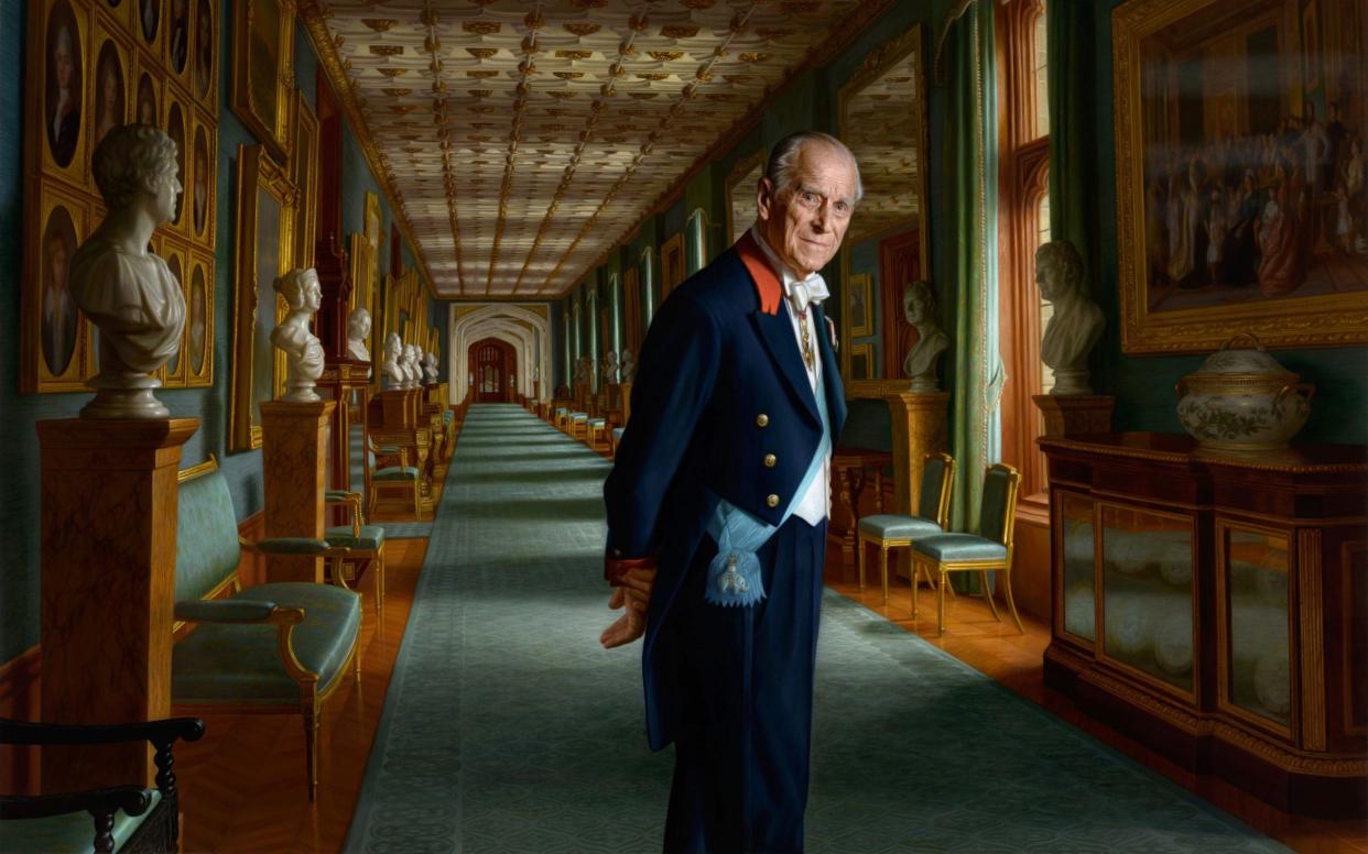 The painting by artist Ralph Heimans, Philip is shown in the imposing setting of Windsor Castle wearing the sash of the Order of the Elephant - PA