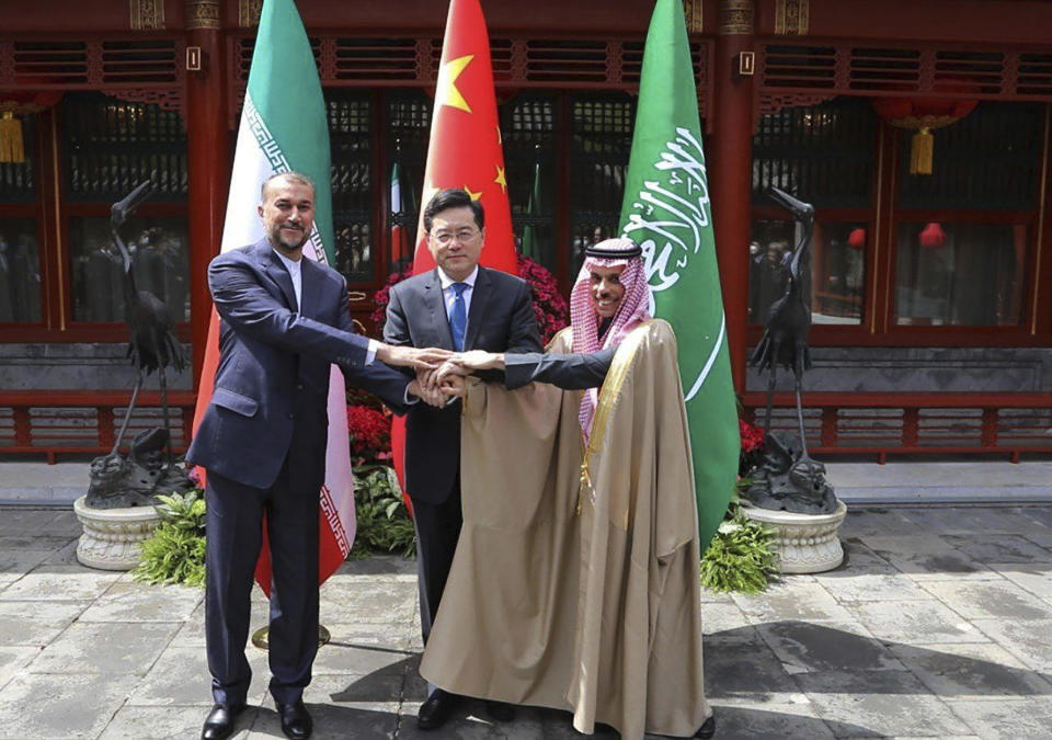 In this picture released by the Iranian Foreign Ministry, Iran's Foreign Minister Hossein Amirabdollahian, left, shakes hands with his Saudi Arabian counterpart Prince Faisal bin Farhan Al Saud, right, and Chineses counterpart Qin Gang in Beijing, April 6, 2023. / Credit: Iranian Foreign Ministry via AP