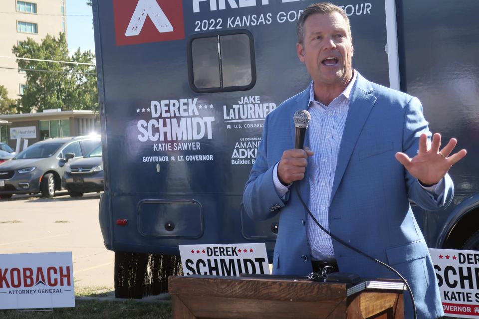 In this photo from Wednesday, Oct. 5, 2022, Kris Kobach, the Republican nominee for Kansas attorney general, makes a short speech at the start of a bus tour across Kansas for GOP candidates in Topeka, Kan. Many Republicans say they're seeing a "new," calmer, steadier Kobach this year after he lost the 2018 race for Kansas governor and a U.S. Senate primary in 2020. (AP Photo/John Hanna)