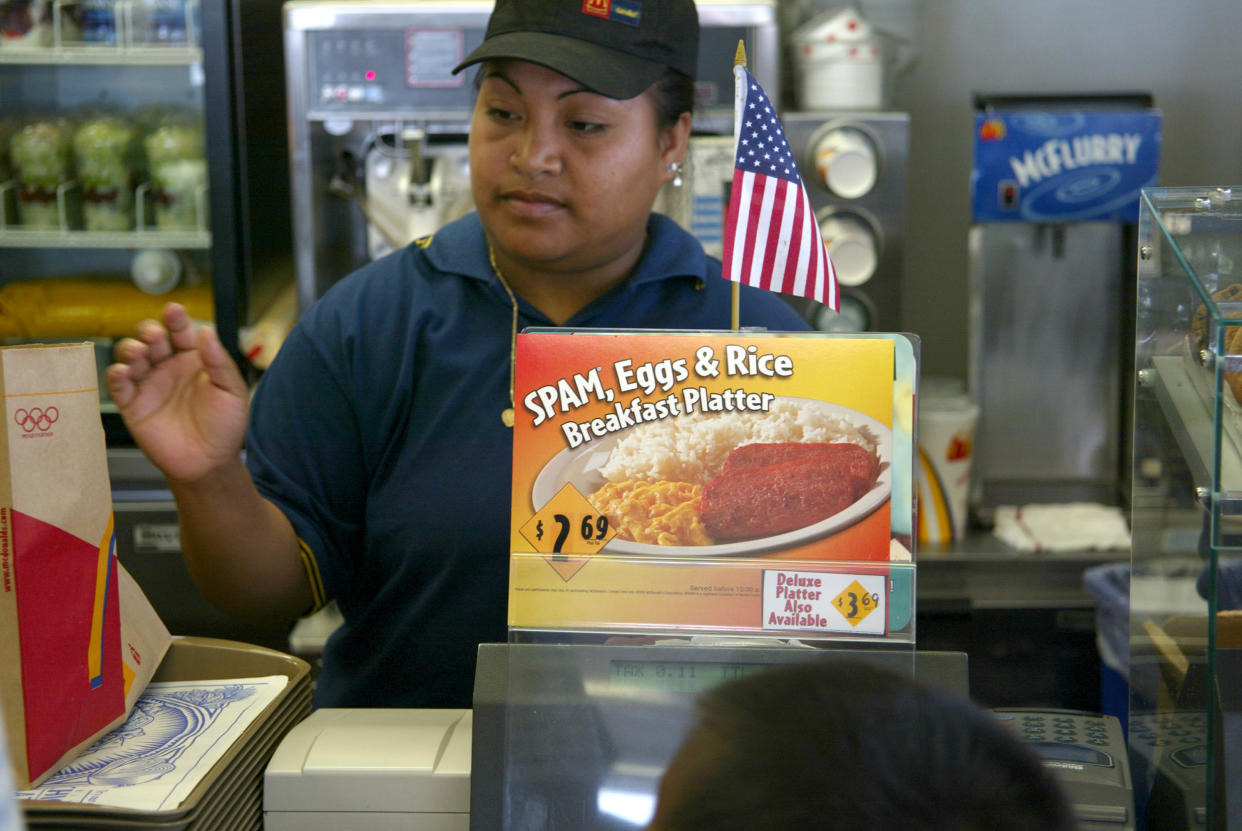 A cashier rings up a sale as the McDonald's new Spam, Eggs and Rice Breakfast Platter is advertised June 11, 2002 in Wahiawa, Hawaii. (Getty Images)