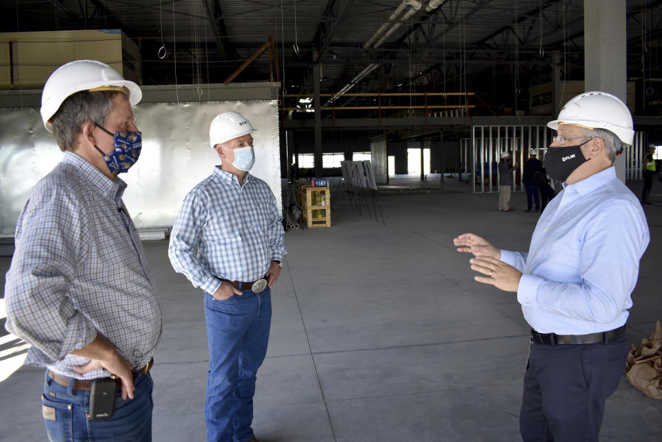 Republicans U.S. Sen. Steve Daines, left, and Rep. Greg Gianforte listen to a representative of FLIR Systems describe the technology company's new facility under construction on Wednesday, Sept. 2, 2020 in Bozeman, Mont. After working together in the corporate world the two Republicans are on the cusp of solidifying their influence over Montana politics for years to come. (AP Photo/Matthew Brown)