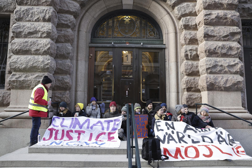 Climate activist Greta Thunberg, third from left, and other protesters, block the entrance of the Swedish Parliament during a climate protest in Stockholm, Sweden, Monday, March 11, 2024. (Christine Olsson/TT News Agency via AP)