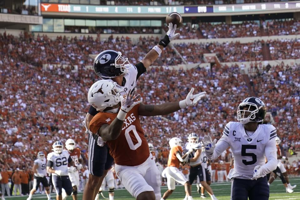 BYU safety Crew Wakley, left, tips away a pass intended for Texas tight end Ja’Tavion Sanders (0) during the second half of an NCAA college football game in Austin, Texas, Saturday, Oct. 28, 2023. | Eric Gay, Associated Press