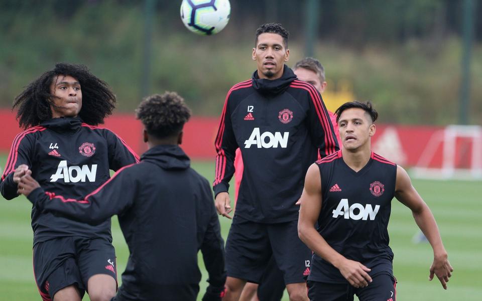 Alexis Sanchez (right) will be thrown straight into the action - Manchester United