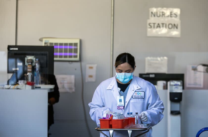 Los Angeles, CA - December 19: Jazmin Escamilla is taking blood samples in the ambulance bay outside the emergency department at MLK Community Hospital on Monday, Dec. 19, 2022, in Los Angeles, CA. (Francine Orr / Los Angeles Times)