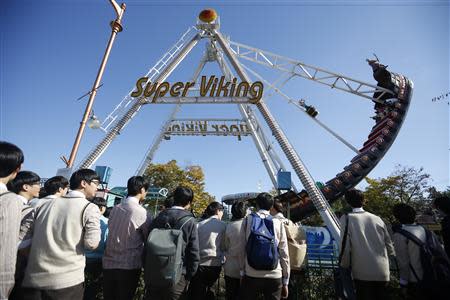 South Korean high school students look at the Super Viking ride at an amusement park in the Imjingak pavilion near the demilitarized zone which separates the two Koreas, in Paju, north of Seoul October 16, 2013. REUTERS/Kim Hong-Ji