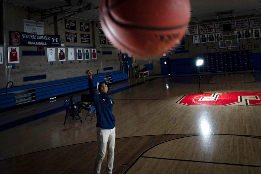 Johnuel “Boogie” Fland shoots hoops in the gymnasium of Archbishop Stepinac High School in White Plains, N.Y., Monday, May 2, 2022. Fland is among a growing number of high school athletes who have signed sponsorship deals for their name, image and likeness following a Supreme Court decision last year that allowed similar deals for college athletes. (AP Photo/Robert Bumsted)