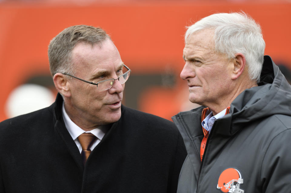 FILE - In this Sunday, Dec. 10, 2017 file photo, Cleveland Browns general manager John Dorsey, left, talks with owner Jimmy Haslam before an NFL football game against the Green Bay Packers in Cleveland. New Browns general manager John Dorsey played linebacker in the NFL. Turns out, he still hits hard. Dorsey, hired last week by owner Jimmy Haslam to fix his floundering franchise, harshly criticized the team’s previous football head Sashi Brown on Thursday, Dec. 14, 2017 saying he failed to give coach Hue Jackson good players. (AP Photo/David Richard, File)