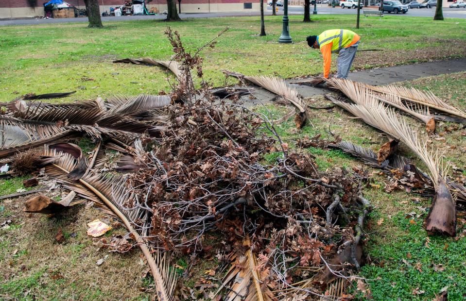 Eleacar Cruz with Brightview Landscape Services cleans up debris at Eden Park in Stockton on Tuesday, Jan. 3, 2023, left by the atmospheric river storm that hit Stockton over the weekend.