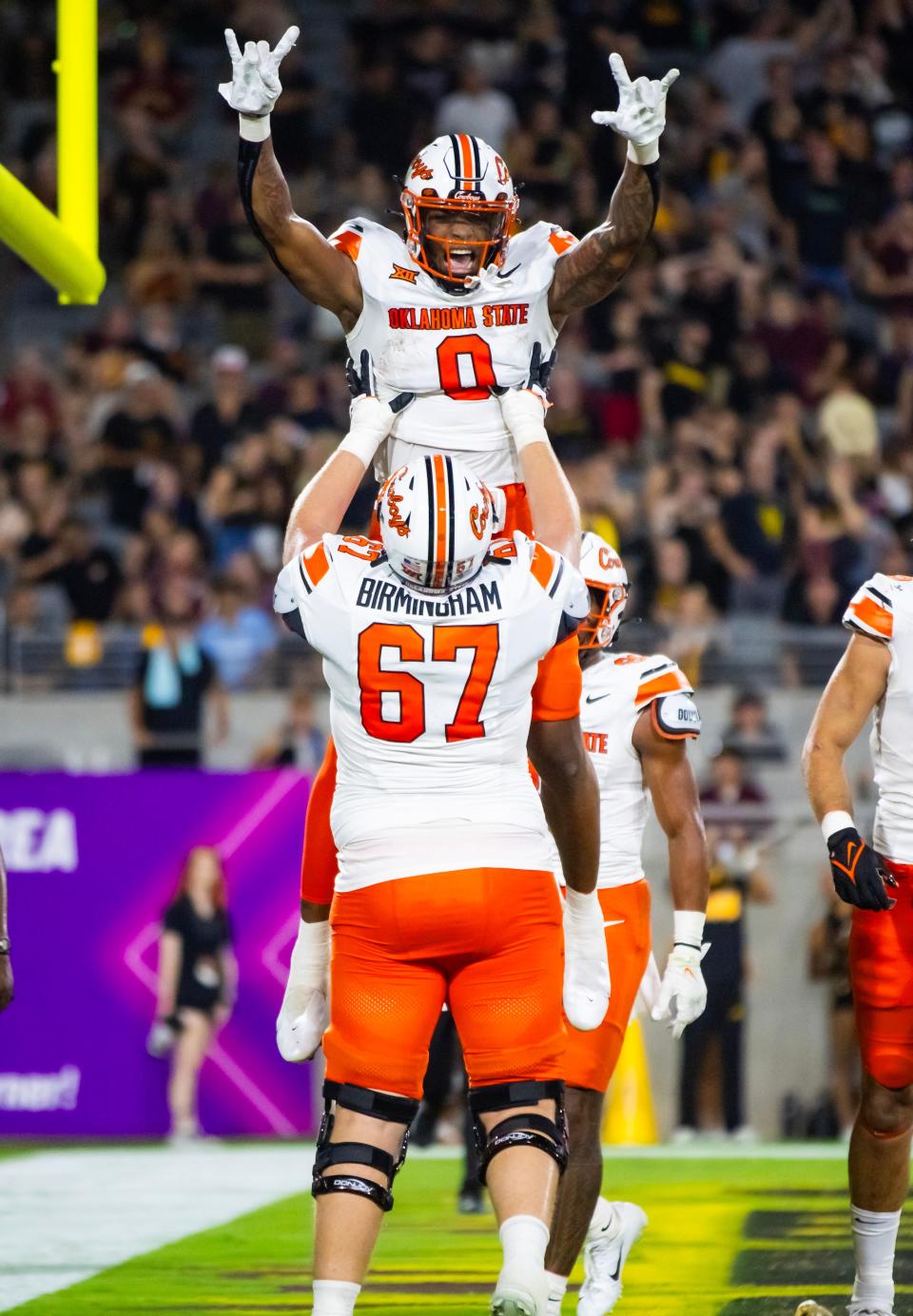 Sep 9, 2023; Tempe, Arizona, USA; Oklahoma State Cowboys running back Ollie Gordon II (0) celebrates a touchdown with offensive lineman Cole Birmingham (67) against the Arizona State Sun Devils in the first half at Mountain America Stadium. Mandatory Credit: Mark J. Rebilas-USA TODAY Sports