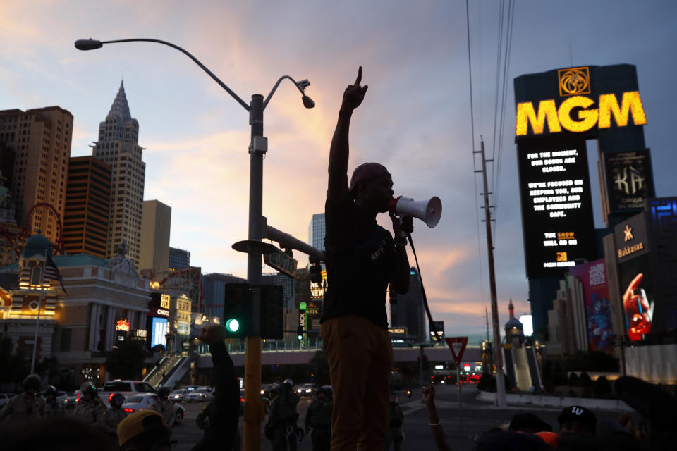 Protesters rally on the Las Vegas Strip Sunday, May 31, 2020, in Las Vegas, over the death of George Floyd, a black man who was in police custody in Minneapolis. Floyd died after being restrained by Minneapolis police officers on Memorial Day. (AP Photo/Steve Marcus)