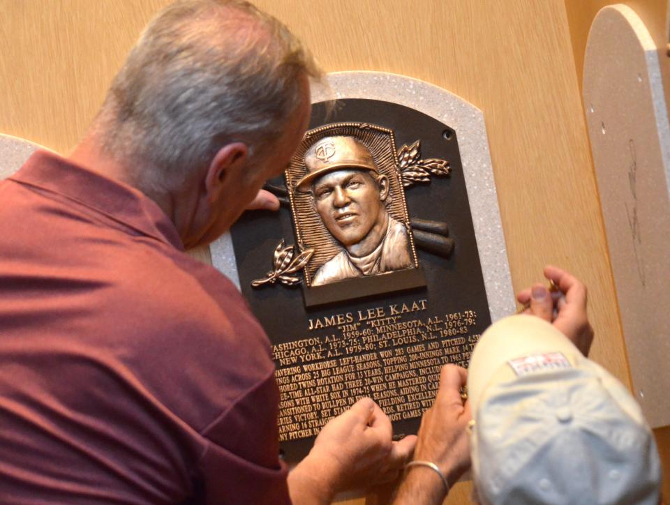 Baseball Hall of Fame staff workers install Jim Kaat's Hall of Fame plaque Sunday, July 24, in Cooperstown, N.Y.