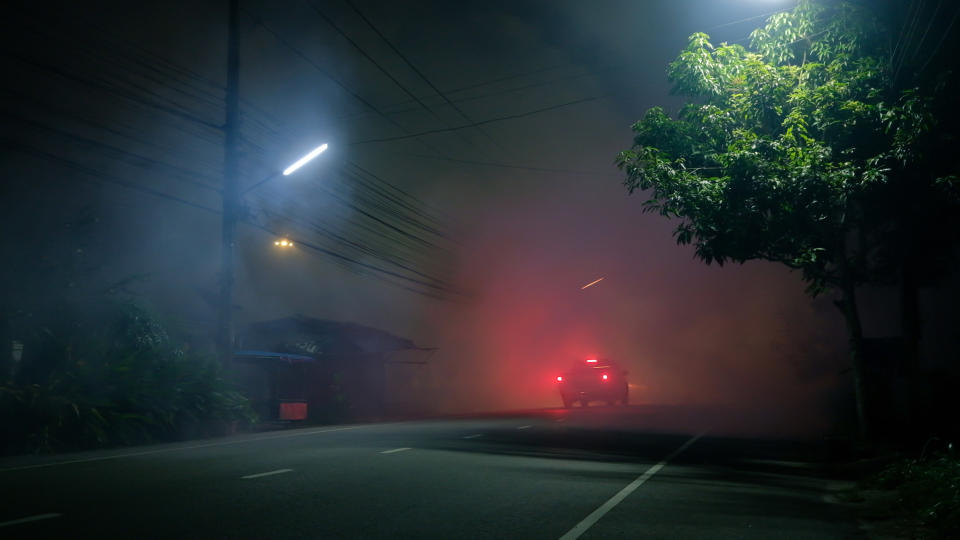 a car driving on a remote road at night