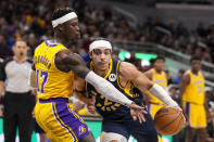 Indiana Pacers guard Andrew Nembhard (2) drives on Los Angeles Lakers guard Dennis Schroder (17) during the second half of an NBA basketball game in Indianapolis, Thursday, Feb. 2, 2023. The Lakers defeated the Pacers 112-111. (AP Photo/Michael Conroy)