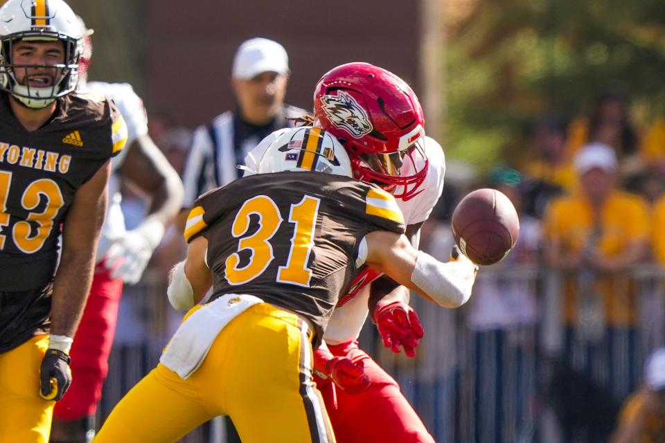 Sep 30, 2023; Laramie, Wyoming, USA; New Mexico Lobos wide receiver Caleb Medford (4) is hit by Wyoming Cowboys safety Wyett Ekeler (31) during the second quarter at Jonah Field at War Memorial Stadium.