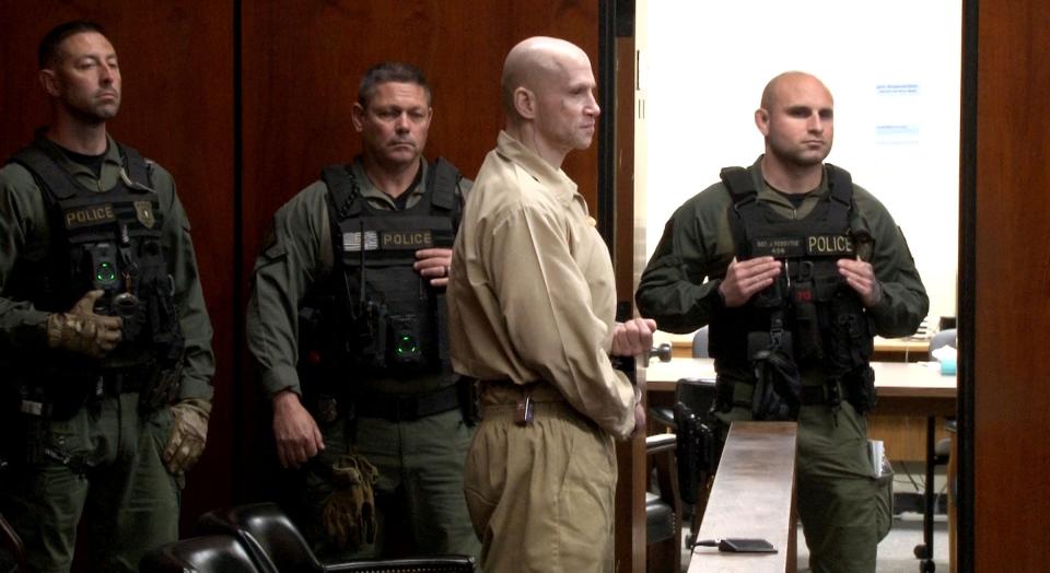 NJ State Corrections officers stand behind Angelo Grenci as he is sentenced for aggravated manslaughter in the fatal stabbing in Berkeley Township of Carlton Williams in 2020. The sentencing was before Superior Court Judge Kimarie Rahill at the Ocean County Courthouse in Toms River Friday, April 19, 2024.