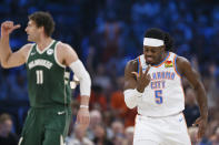 Oklahoma City Thunder guard Luguentz Dort (5) celebrates after making a 3-point basket near Milwaukee Bucks center Brook Lopez (11) during the first half of an NBA basketball game Friday, April 12, 2024, in Oklahoma City. (AP Photo/Nate Billings)