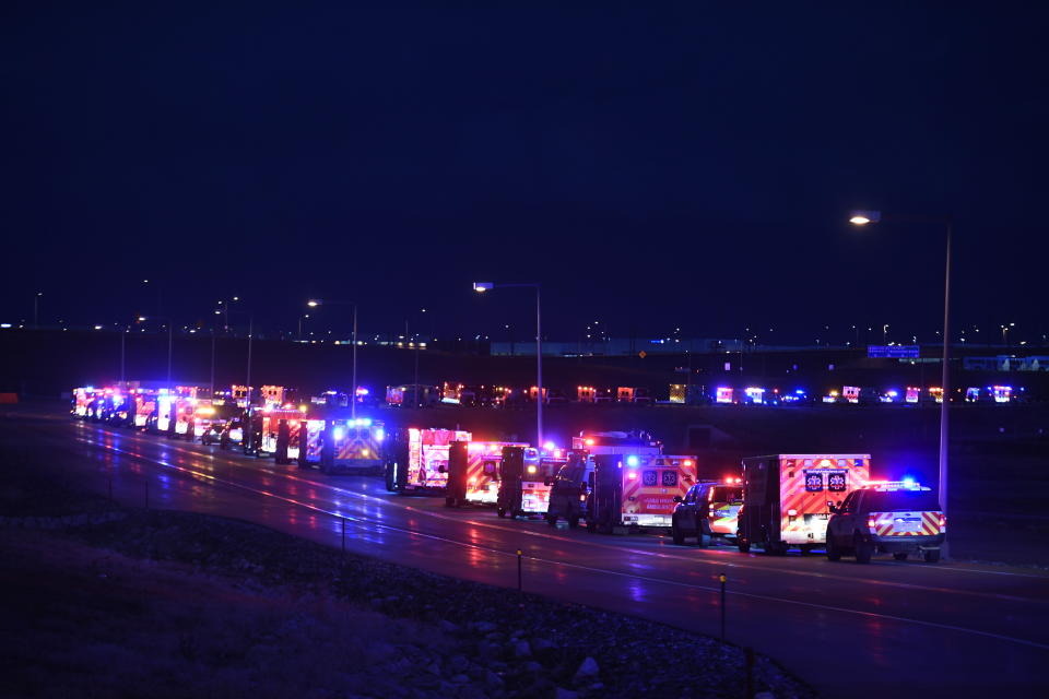 The procession of emergency vehicles for retired paramedic Paul Cary makes its way out of Denver International Airport on Sunday, May 3, 2020, in Denver. Cary died from coronavirus after volunteering to help combat the pandemic in New York City. (Helen H. Richardson/The Denver Post via AP, Pool)