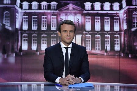 Emmanuel Macron, head of the political movement En Marche !, or Onwards !, and candidate for the 2017 presidential election, poses before taking part in the show "Elysee 2017" on French television channel TF1 in Paris, France, April 27, 2017. REUTERS/Eric Feferberg/Pool