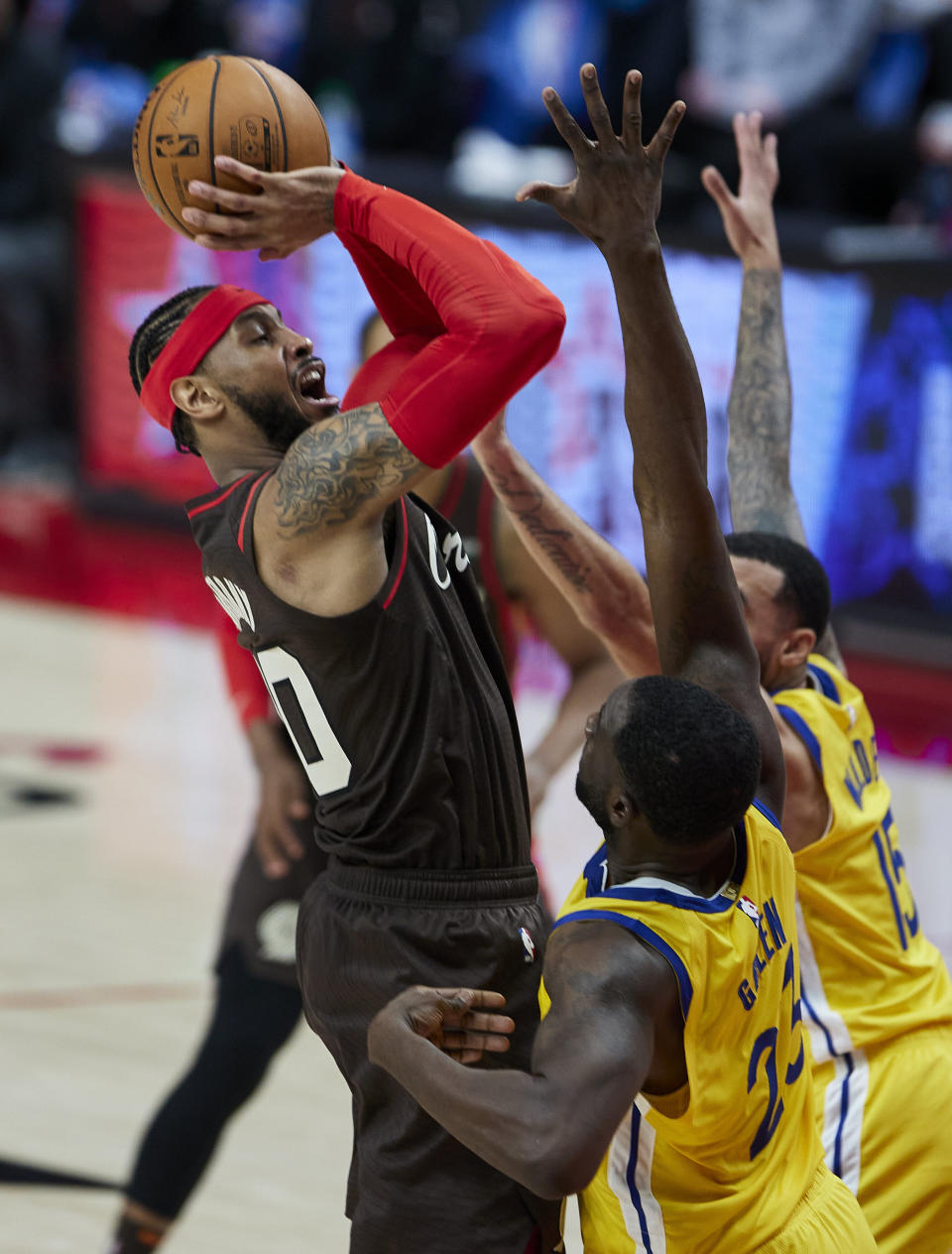 Portland Trail Blazers forward Carmelo Anthony, left, shoots over Golden State Warriors forward Draymond Green, front, and guard Mychal Mulder during the second half of an NBA basketball game in Portland, Ore., Wednesday, March 3, 2021. (AP Photo/Craig Mitchelldyer)