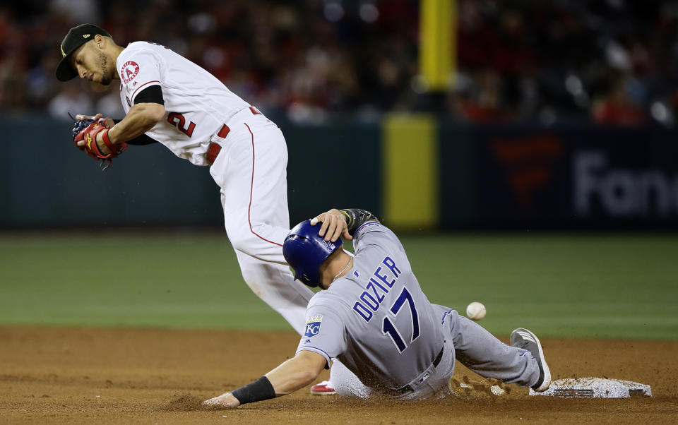 Kansas City Royals' Hunter Dozier, right, is forced out at second, but Los Angeles Angels shortstop Andrelton Simmons, left, loses the ball on the transfer, as Ryan O'Hearn is safe at first during the fifth inning of a baseball game in Anaheim, Calif., Saturday, May 18, 2019. (AP Photo/Alex Gallardo)