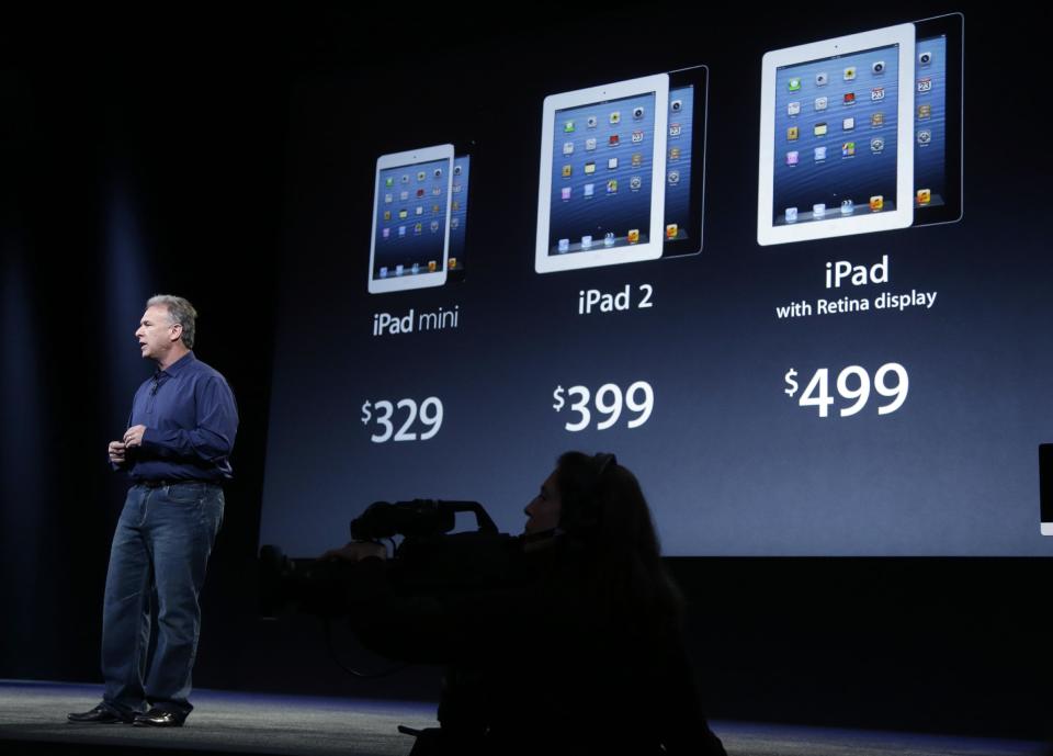 Phil Schiller, Apple's senior vice president of worldwide product marketing, displays the prices of the company's various iPad products in San Jose, Calif., Tuesday, Oct. 23, 2012. Apple Inc. is refusing to compete on price with its rivals in the tablet market, it's pricing its new, smaller iPad well above the competition. On Tuesday, the company revealed the iPad Mini, with a screen that's about two-thirds the size of the full-size model, and said it will cost $329 and up. (AP Photo/Marcio Jose Sanchez)