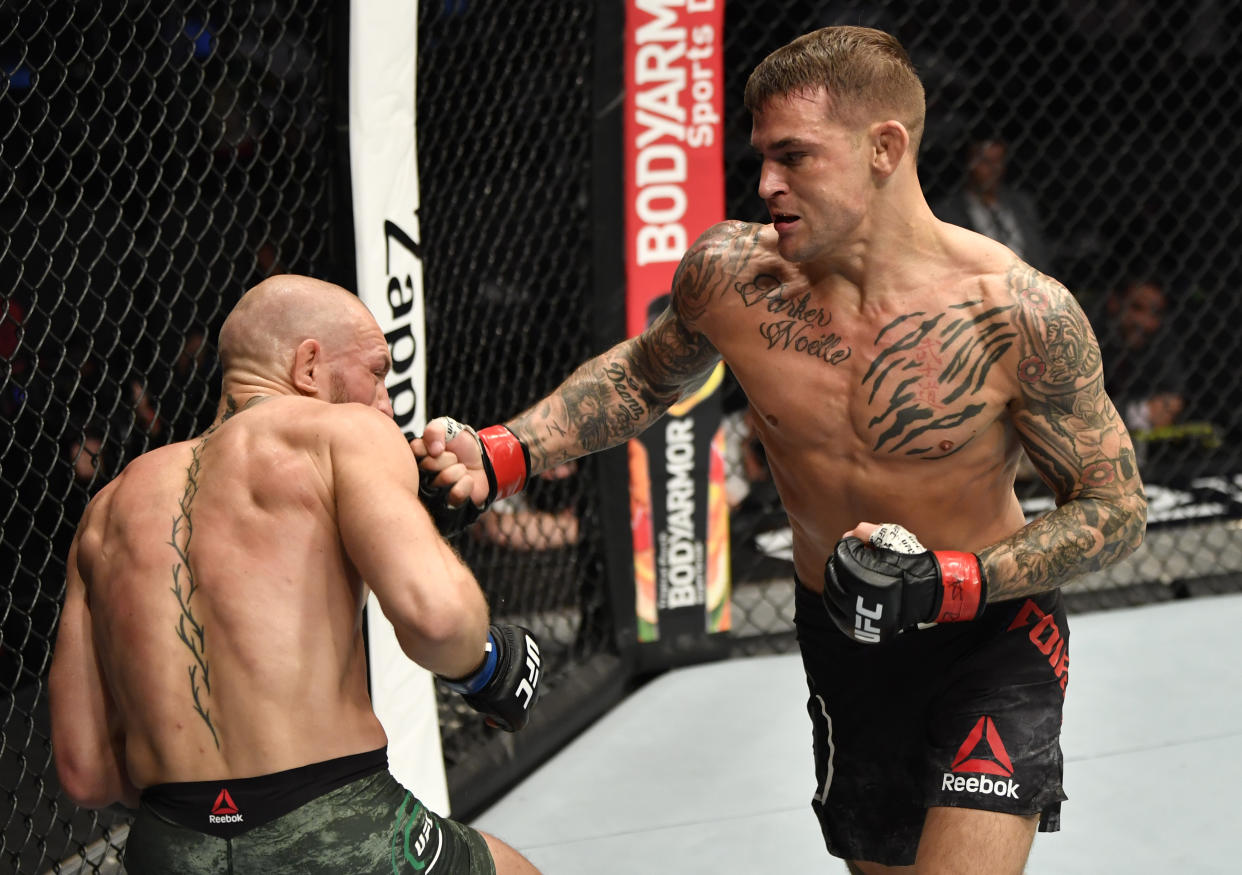 ABU DHABI, UNITED ARAB EMIRATES - JANUARY 23: (R-L) Dustin Poirier punches Conor McGregor of Ireland in a lightweight fight during the UFC 257 event inside Etihad Arena on UFC Fight Island on January 23, 2021 in Abu Dhabi, United Arab Emirates. (Photo by Jeff Bottari/Zuffa LLC)