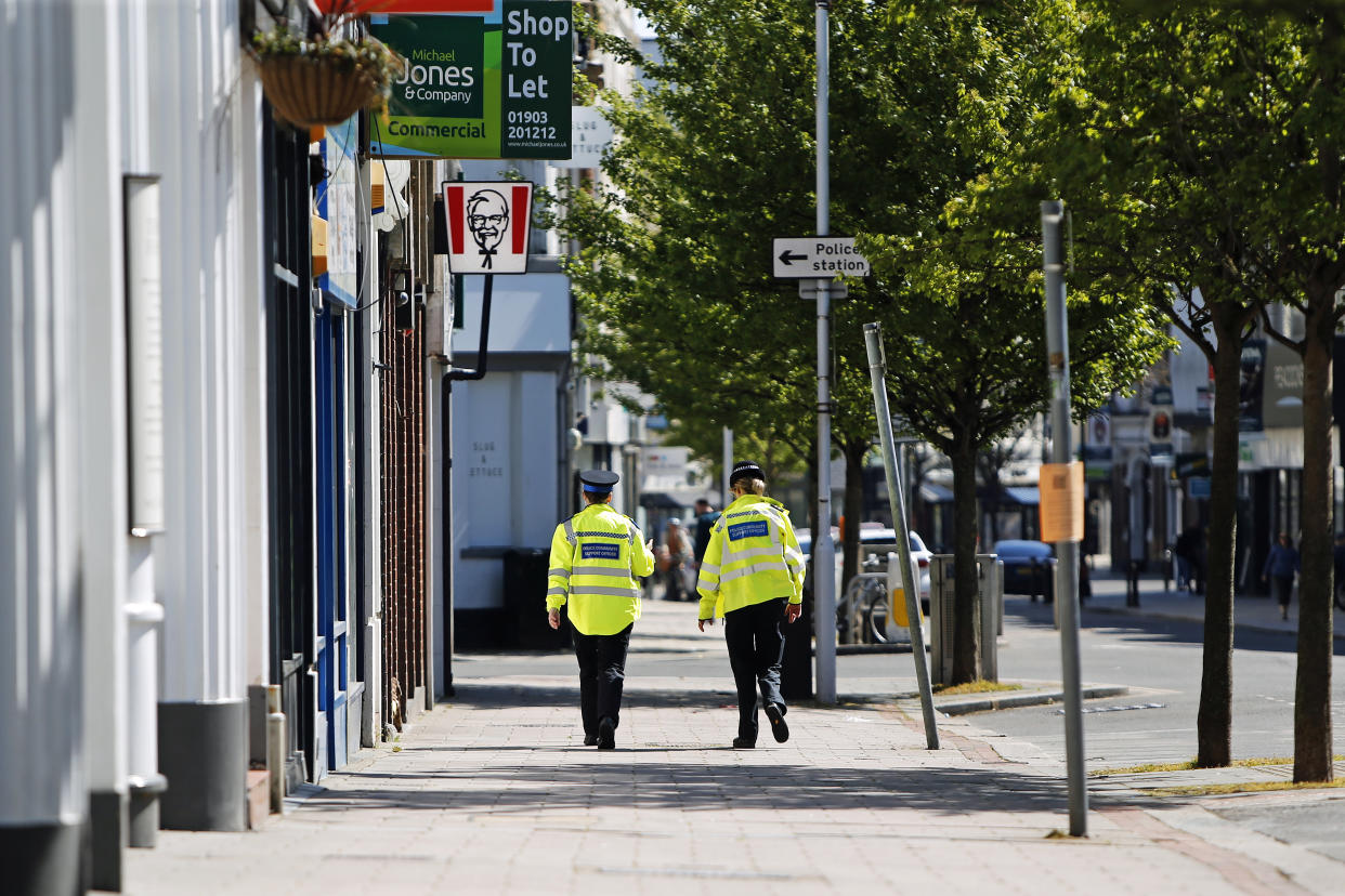 Two police officers walk through Worthing town centre as the UK continues in lockdown to help curb the spread of the coronavirus.