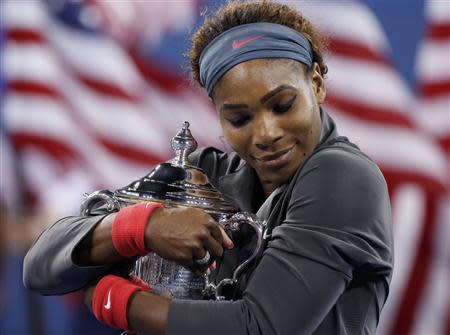 Serena Williams of the U.S. embraces her trophy after defeating Victoria Azarenka of Belarus in their women's singles final match at the U.S. Open tennis championships in New York September 8, 2013. REUTERS/Mike Segar