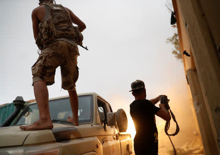 Fighters loyal to Libya's U.N.-backed government (GNA) fire guns during clashes with forces loyal to Khalifa Haftar on the outskirts of Tripoli, Libya May 25, 2019. REUTERS/Goran Tomasevic