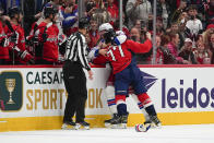 Washington Capitals right wing T.J. Oshie (77) and New York Rangers center Barclay Goodrow fight during the first period of an NHL hockey game, Saturday, Feb. 25, 2023, in Washington. (AP Photo/Julio Cortez)