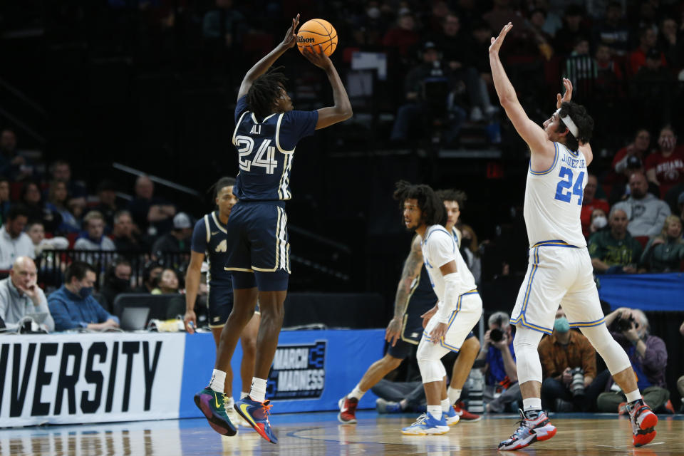 Akron forward Ali Ali, left, shoots over UCLA guard Jaime Jaquez Jr., right, during the first half of a first-round NCAA college basketball tournament game, Thursday, March 17, 2022, in Portland, Ore. (AP Photo/Craig Mitchelldyer)