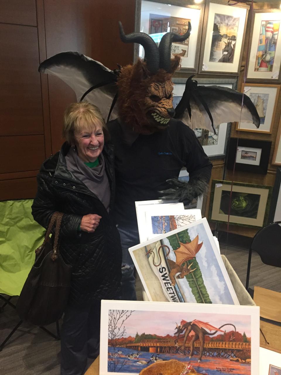 A visitor to Lines on the Pines at Stockton University in Galloway, N.J. poses with the Jersey Devil, in this 2018 file photo.