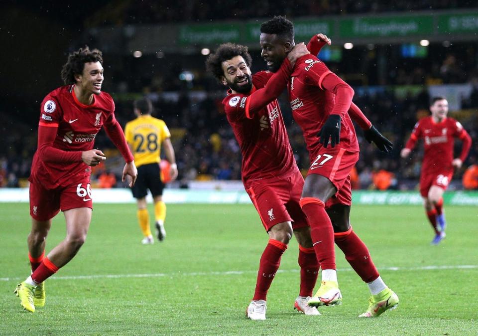 Divock Origi (right) celebrates his late Liverpool winner at Wolves with team-mates Trent Alexander-Arnold and Mohamed Salah (Nigel French/PA Images). (PA Wire)