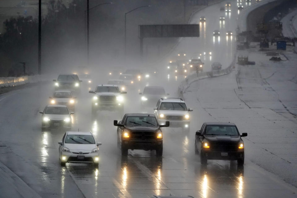 Traffic makes its way along interstate 5 during a rainstorm Friday, Feb. 24, 2023, in Santa Clarita, Calif. California and other parts of the West faced heavy snow and rain Friday from the latest winter storm to pound the U.S. (AP Photo/Marcio Jose Sanchez)