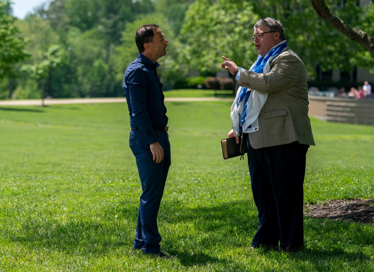 Associate Professor of Finance Dr. Khaled Elkhal and Landmark Baptist Church Pastor Sam Robinson discuss the war in Gaza while students gather in protest at the University of Southern Indiana in Evansville, Ind., Tuesday, April 30, 2024.