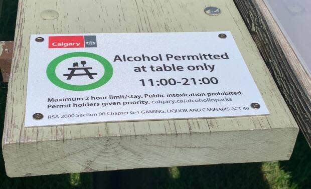 The City of Calgary is past the halfway point of its alcohol in parks program, running June 1 to Sept. 7, 2021. Signs are posted on designated picnic tables in city parks explaining the rules. (Mike Symington - image credit)