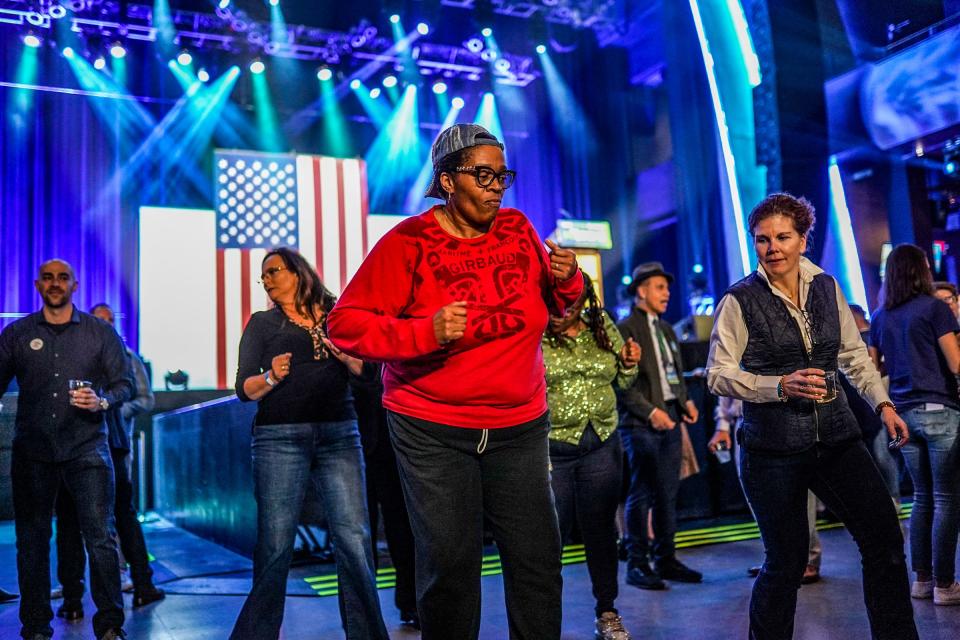 People dance while waiting for speakers during the Michigan Democratic watch party for the midterm elections at the Motor City Casino Sound Board in Detroit on Tuesday, Nov. 8, 2022.