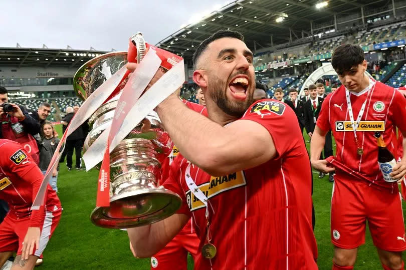 Photo showing Cliftonville’s Joe Gormley with the cup