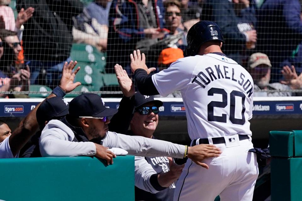 Tigers'  Spencer Torkelson is greeted at the dugout after scoring during the third inning against the Red Sox, Tuesday, April 12, 2022, in Detroit.