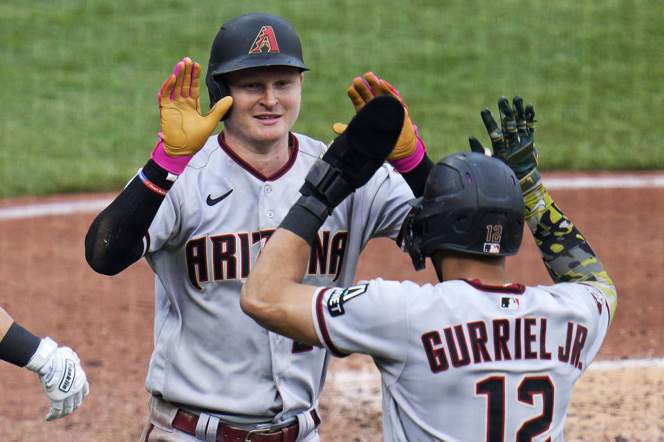 Arizona Diamondbacks' Pavin Smith, left, celebrates with Lourdes Gurriel Jr. (12) after hitting a two-run home run off Pittsburgh Pirates relief pitcher Robert Stephenson during the seventh inning of a baseball game in Pittsburgh, Saturday, May 20, 2023. (AP Photo/Gene J. Puskar)