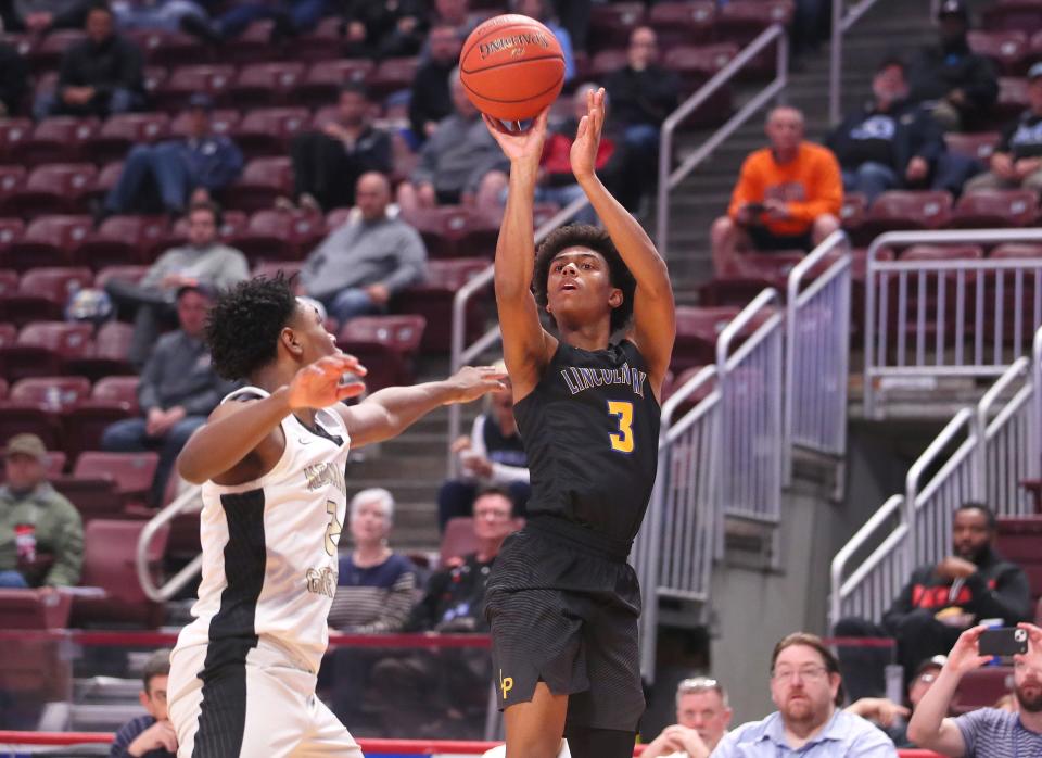 Lincoln Park's Brandin Cummings (3) shoots a three point shot after gaining space from Neumann-Goretti's Robert Wright (2) during the second half of the PIAA 4A Championship game Thursday night at the Giant Center in Hershey, PA.