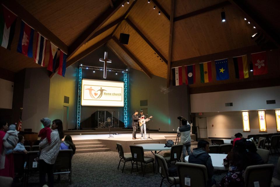 Home Church's pastor, Mishael Bhujel, left, helps lead a service on Nov. 14. The church that ministers to people from Bhutan and Nepal has found a home in First Alliance Church's building on the Northwest Side.