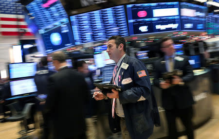 Traders work on the floor of the New York Stock Exchange (NYSE) in New York, U.S., December 11, 2018. REUTERS/Brendan McDermid