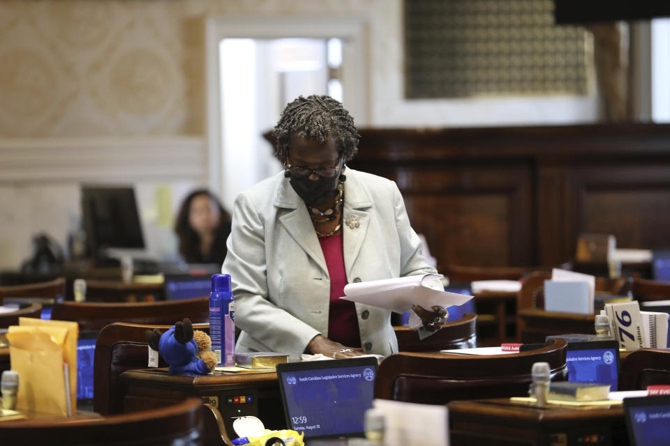 South Carolina Rep. Gilda Cobb-Hunter, D-Orangeburg, cleans her desk before a House session on a total ban on abortion on Tuesday, Aug. 30, 2022, in Columbia, S.C. (AP Photo/Jeffrey Collins)