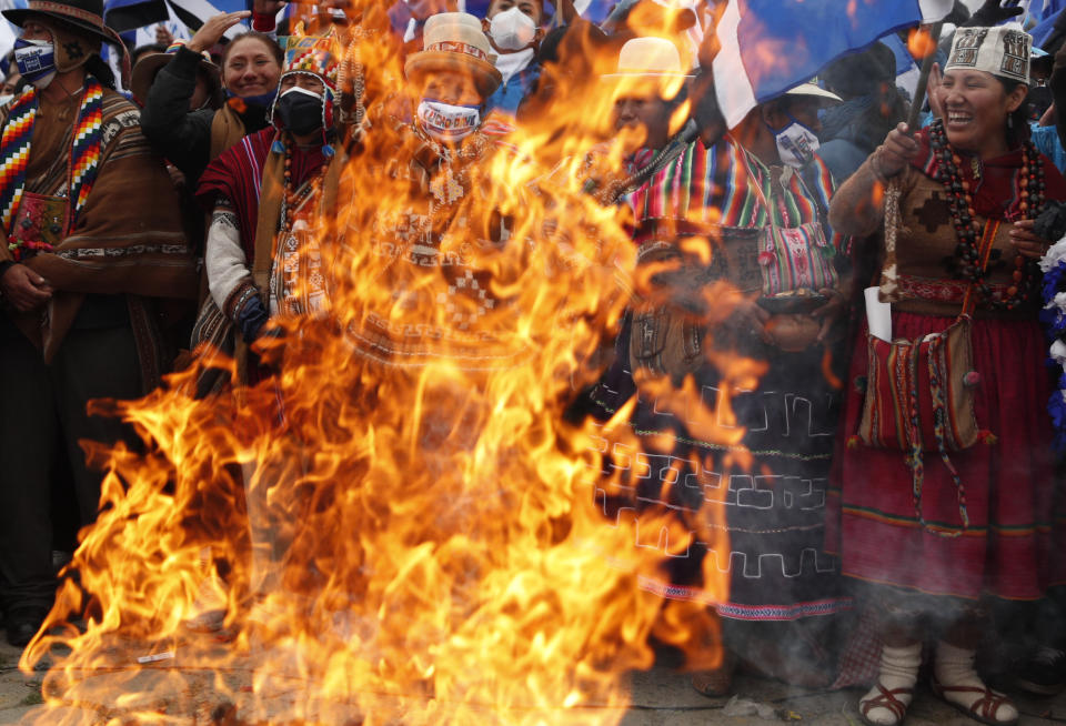 Supporters of presidential candidate Luis Arce from the Movement Towards Socialism Party, MAS, burn an offering to the "Pachamama," or Mother Earth during his closing campaign rally in El Alto, Bolivia, Wednesday, Oct. 14, 2020. Elections will be held Oct. 18. (AP Photo/Juan Karita)