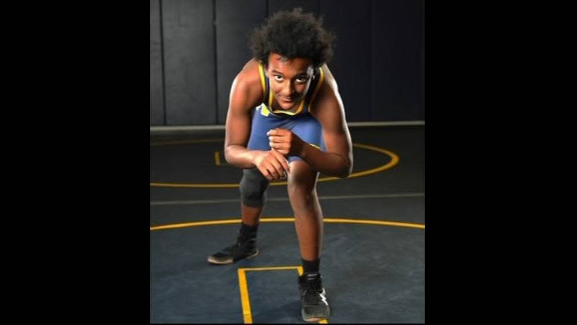 Claude Hodges Jr. poses for a photo in November in the Northwest High School wrestling room. The 14-year-old freshman was found fatally shot Monday.