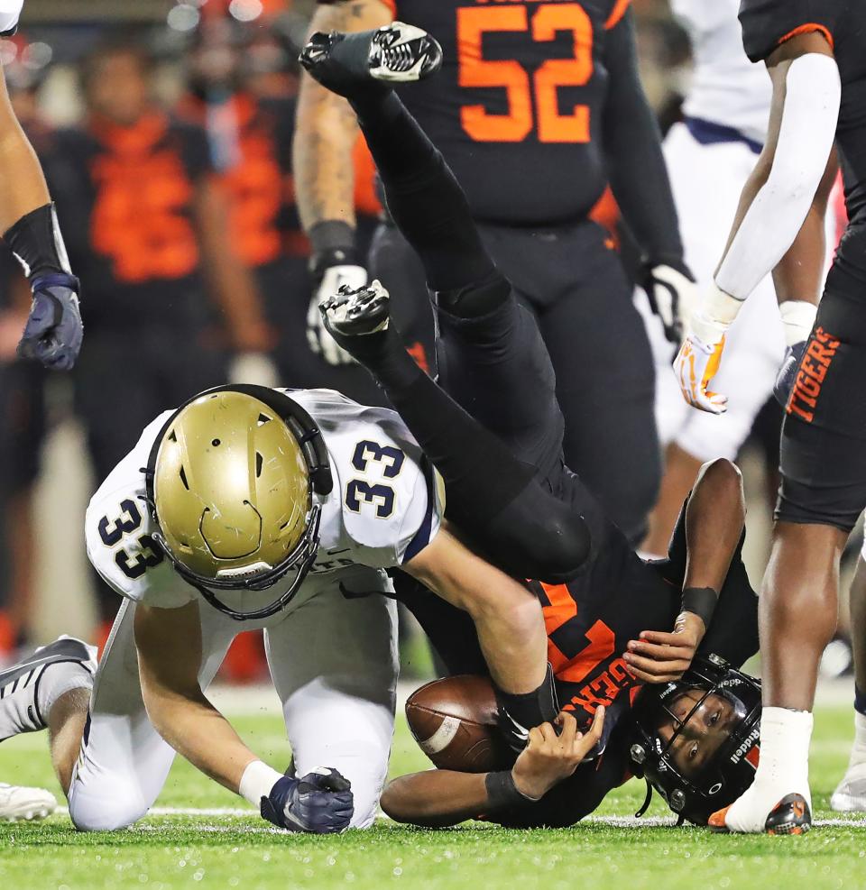 Hoban linebacker Eli Lee, left, stops Massillon quarterback Jalen Slaughter for a first-half loss during an OHSAA Division II state semifinal, Friday, Nov. 25, 2022, in Akron.